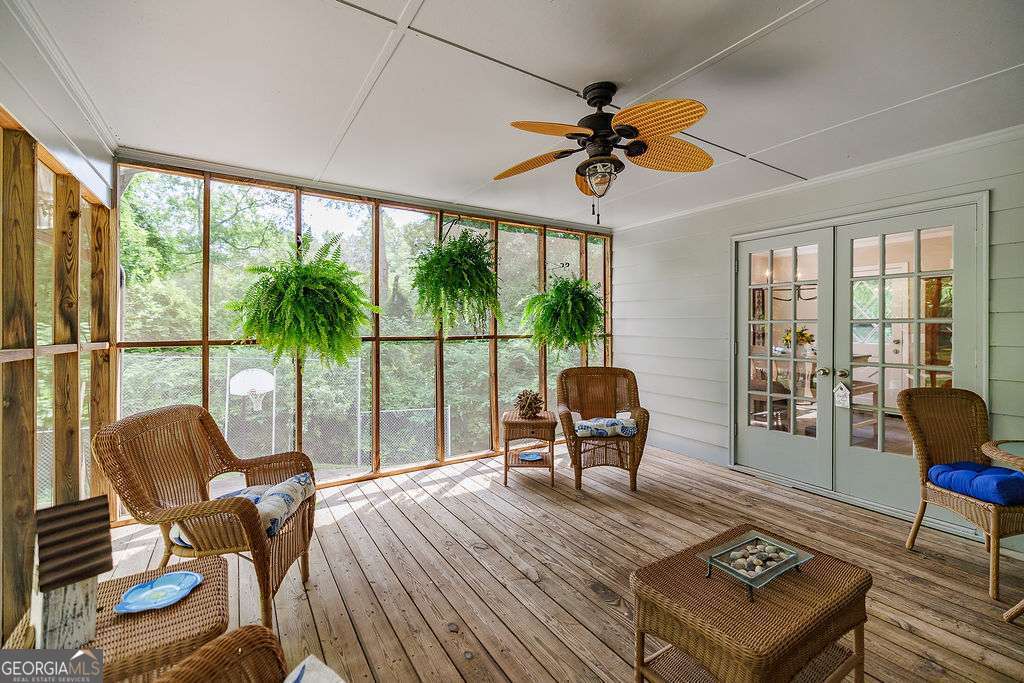 226 Baker Street Statham, GA 30666 - Photo 36 of 63 a living room filled with furniture and a floor to ceiling window
