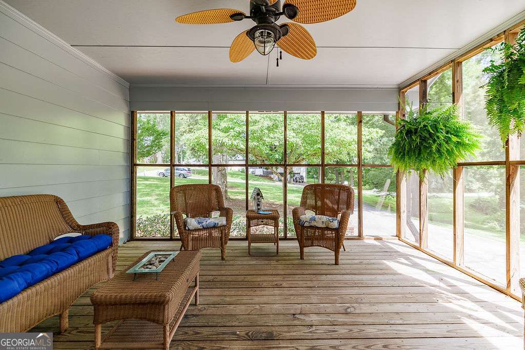 226 Baker Street Statham, GA 30666 - Photo 37 of 63 a living room with furniture and a floor to ceiling window