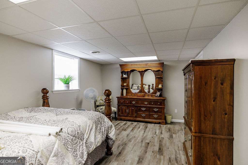 226 Baker Street Statham, GA 30666 - Photo 52 of 63 a bed room with a bed and a dresser