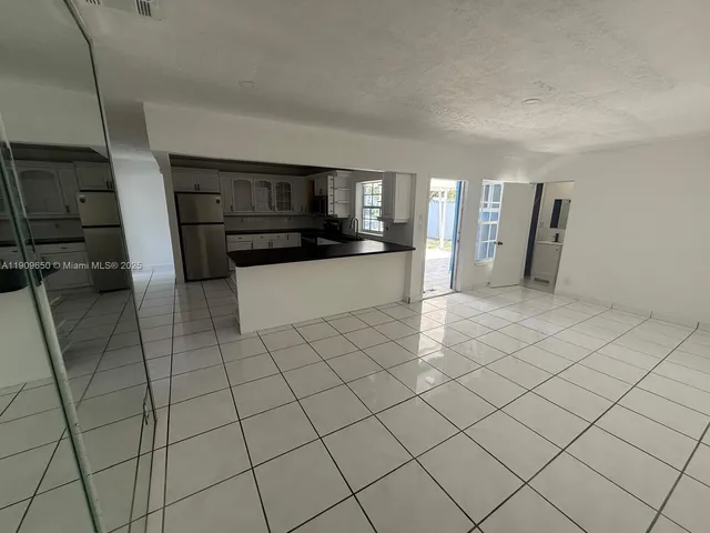 a view of a refrigerator and window in a room