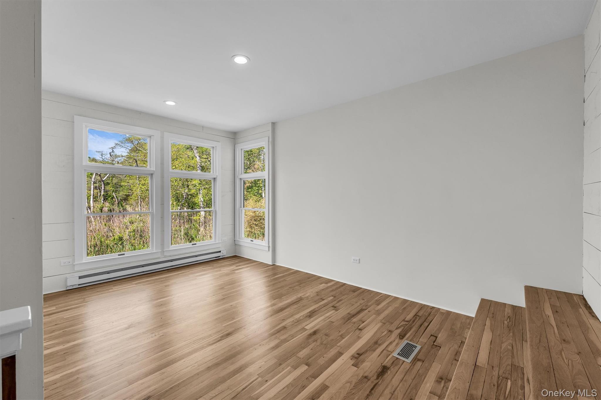 238 Beaver Dam Road Brookhaven, NY 11719 - Photo 11 of 44 a view of an empty room with wooden floor and a window