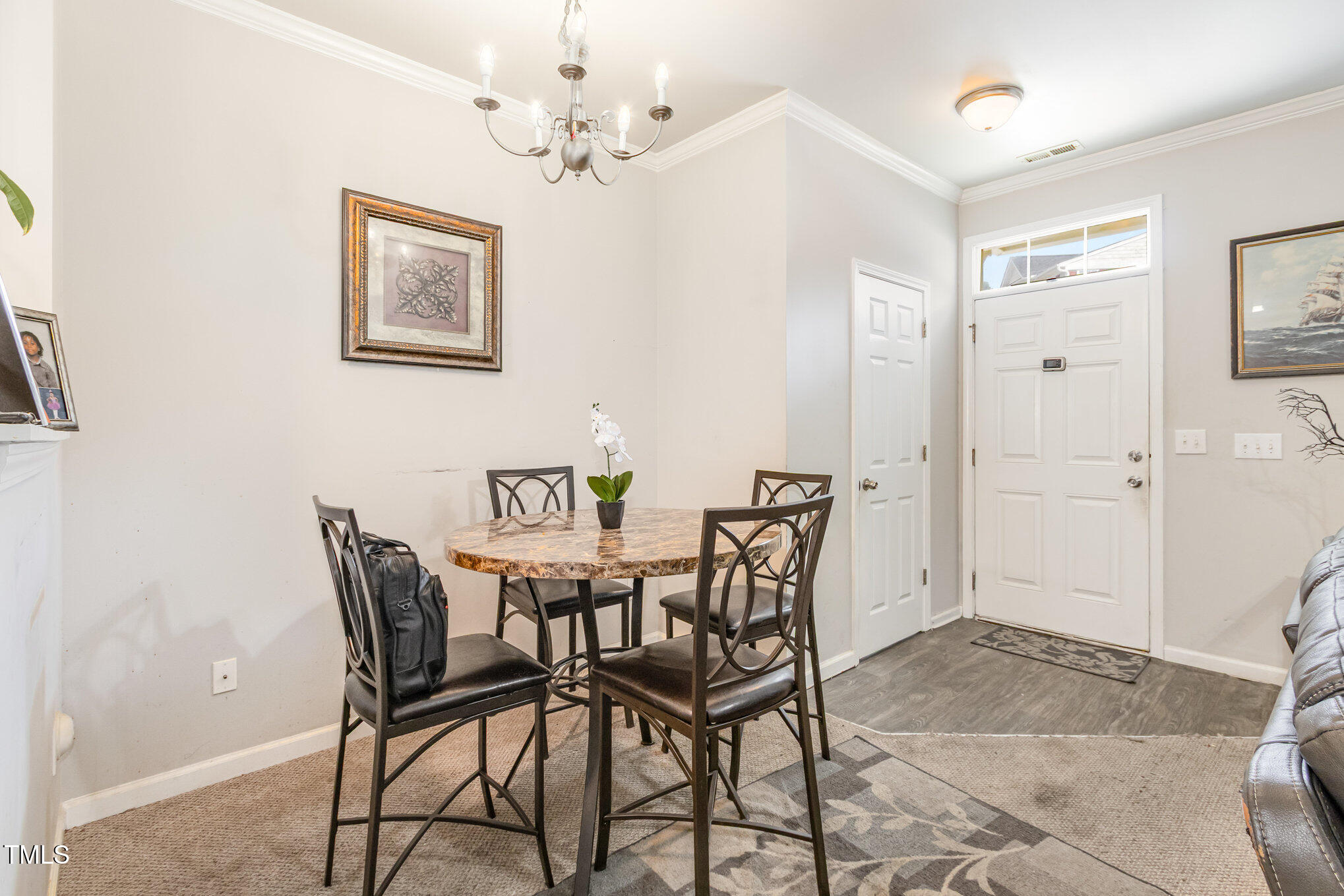2220 Raven Road, Unit 104 Raleigh, NC 27614 - Photo 10 of 22 a view of a dining room with furniture and chandelier