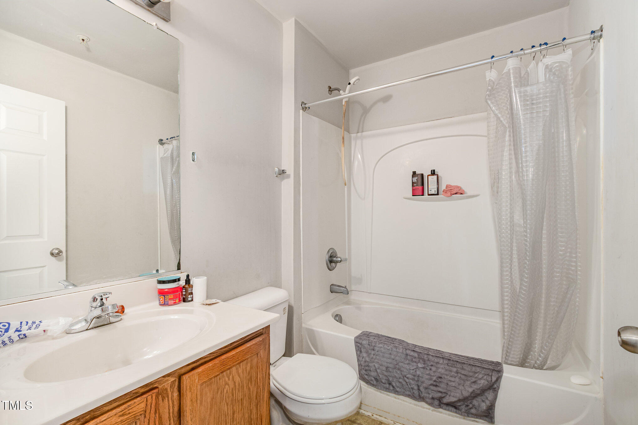 2220 Raven Road, Unit 104 Raleigh, NC 27614 - Photo 17 of 22 a bathroom with a sink a toilet and shower curtain