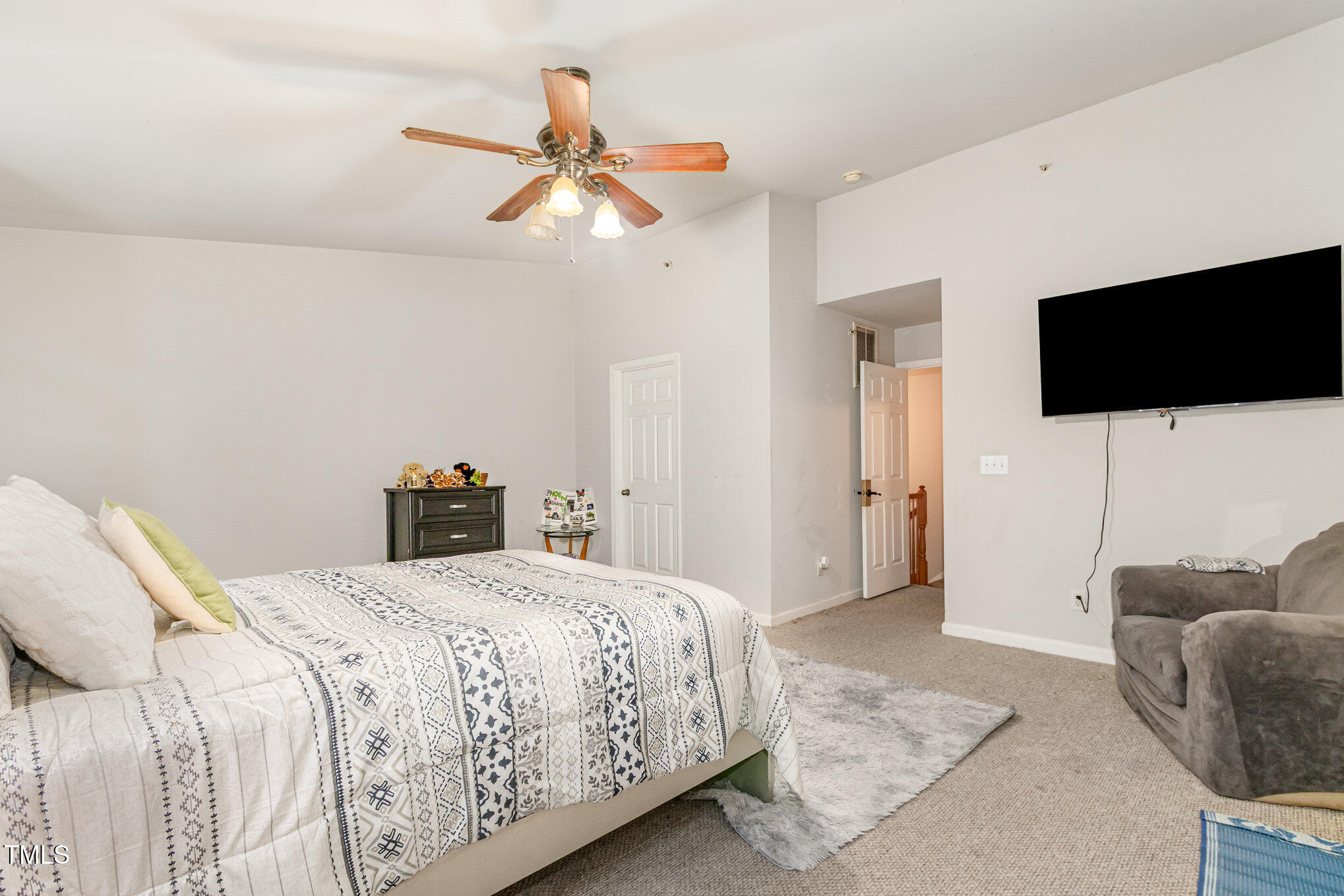 2220 Raven Road, Unit 104 Raleigh, NC 27614 - Photo 20 of 22 a bedroom with a bed a flat screen tv and a couch