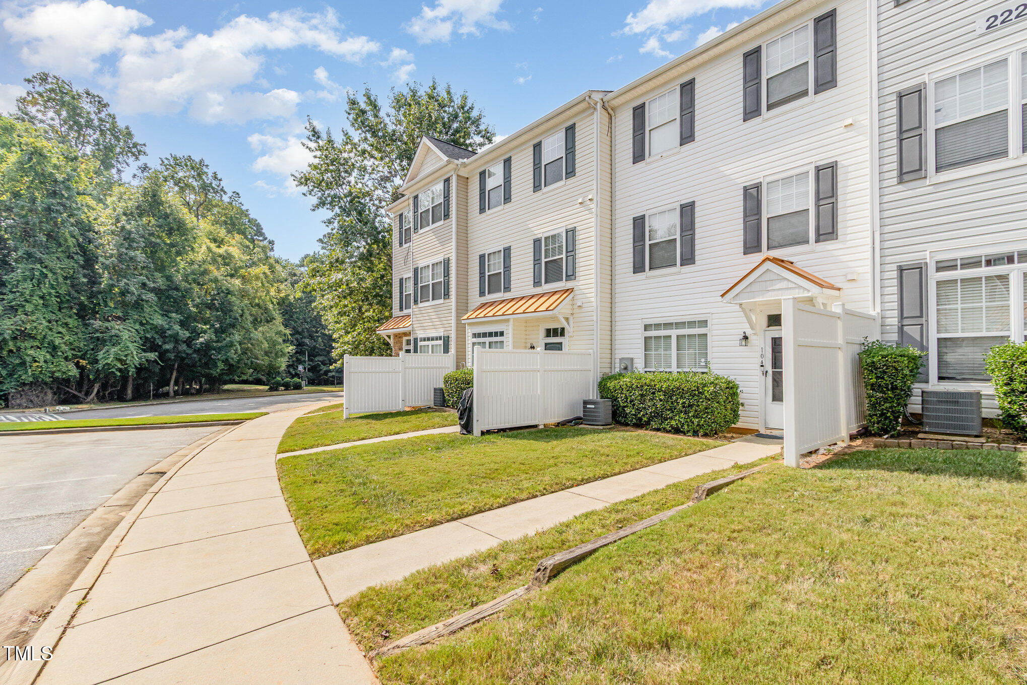 2220 Raven Road, Unit 104 Raleigh, NC 27614 - Photo 2 of 22 a front view of a building with garden and trees