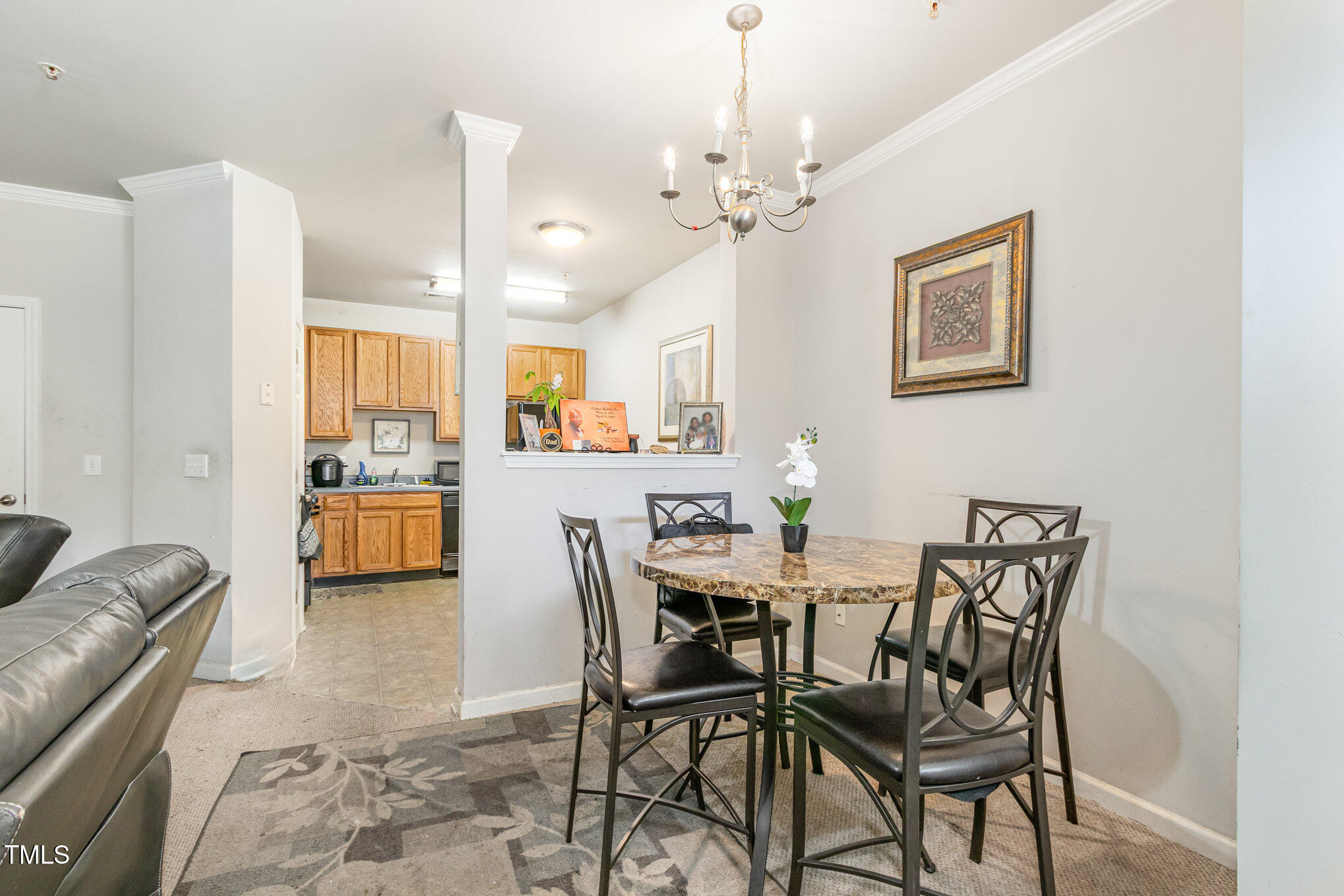 2220 Raven Road, Unit 104 Raleigh, NC 27614 - Photo 9 of 22 a view of a dining room with furniture and a chandelier