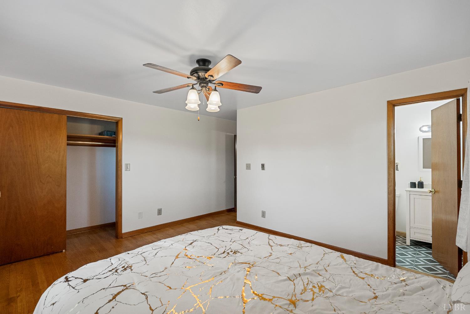 294 Spring Garden Road Monroe, VA 24574 - Photo 22 of 56 a bedroom with a large bed and a chandelier