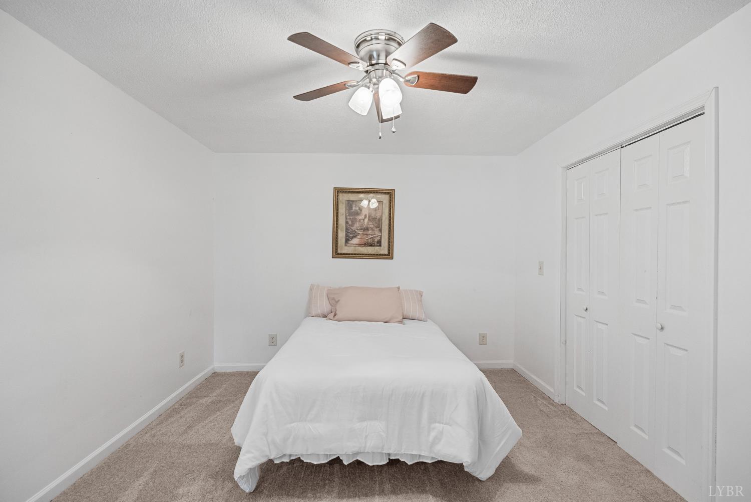 294 Spring Garden Road Monroe, VA 24574 - Photo 27 of 56 a bedroom with a bed and a chandelier
