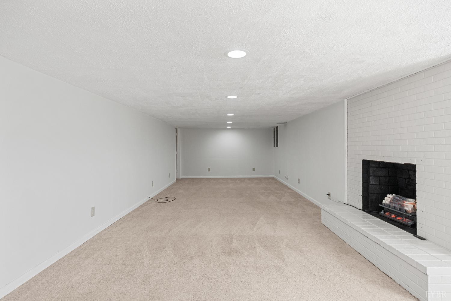 294 Spring Garden Road Monroe, VA 24574 - Photo 28 of 56 an empty room with fireplace and window