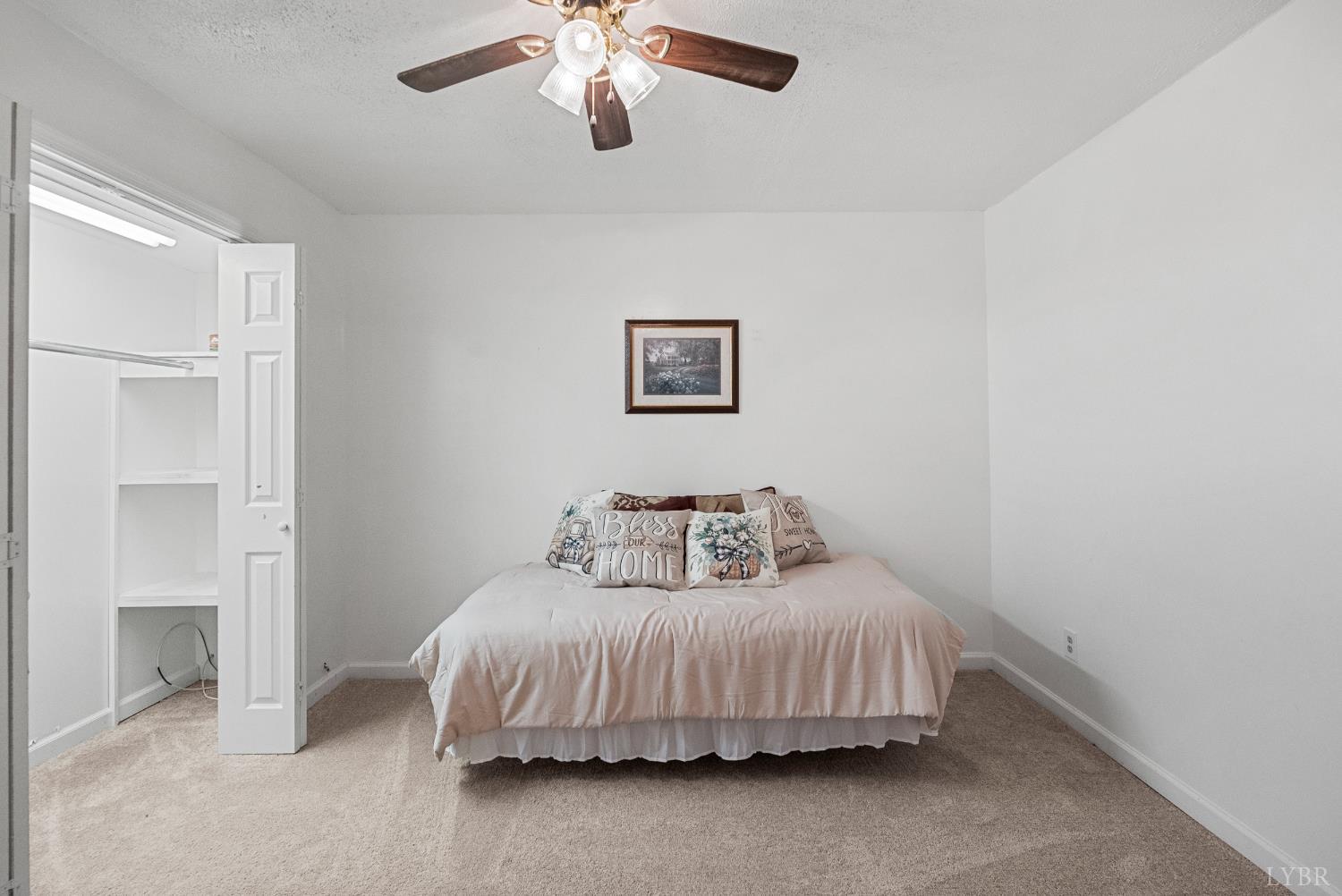 294 Spring Garden Road Monroe, VA 24574 - Photo 31 of 56 a bedroom with a bed and a chandelier