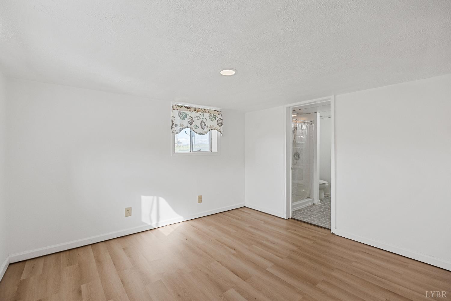 294 Spring Garden Road Monroe, VA 24574 - Photo 33 of 56 a view of an empty room with wooden floor and a window
