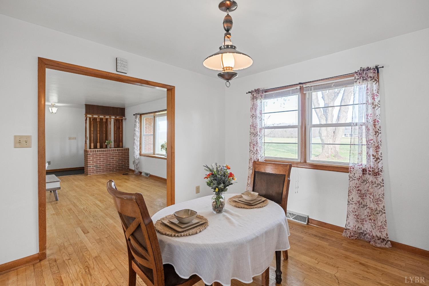 294 Spring Garden Road Monroe, VA 24574 - Photo 7 of 56 a view of a dining room with furniture window and wooden floor