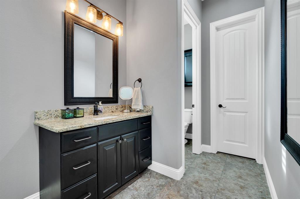 5811 Limestone Lane Midlothian, TX 76065 - Photo 15 of 40 a bathroom with a granite countertop sink and a mirror