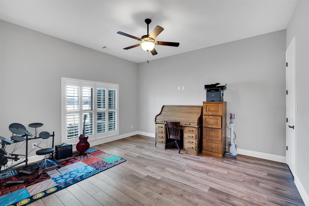 5811 Limestone Lane Midlothian, TX 76065 - Photo 17 of 40 a living room with furniture a flat screen tv and a large window
