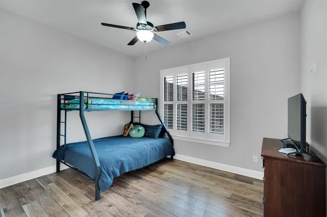 a en suite bathroom with a granite countertop sink and a mirror