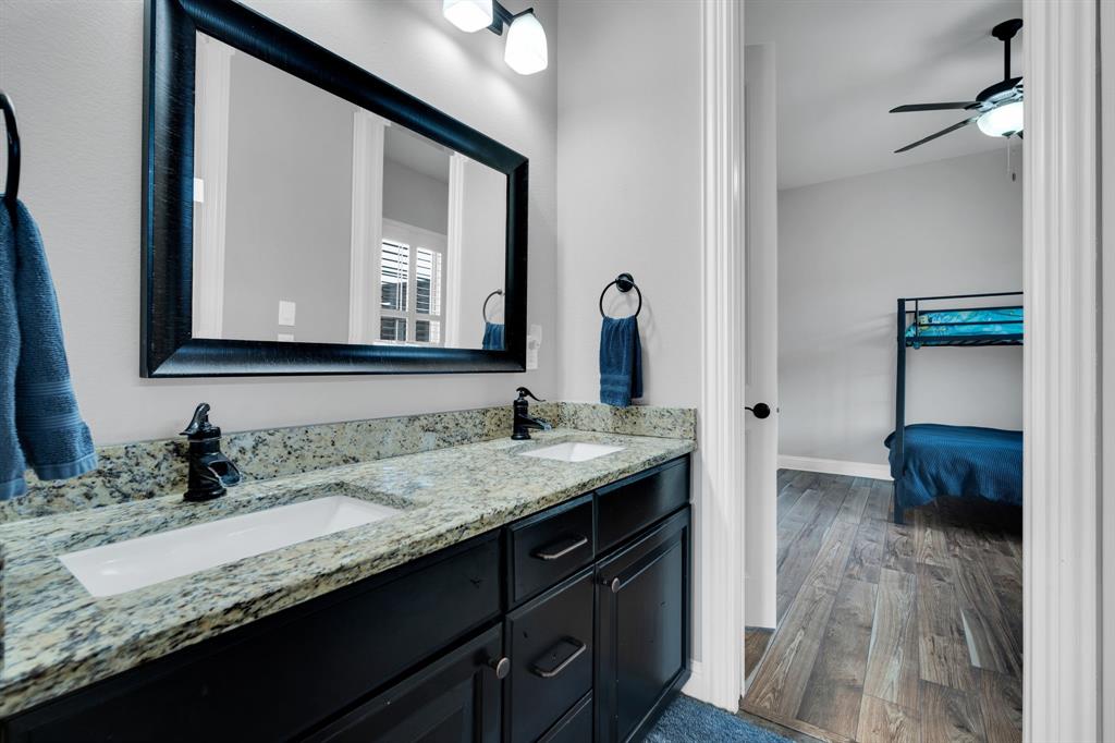5811 Limestone Lane Midlothian, TX 76065 - Photo 23 of 40 a en suite bathroom with a granite countertop sink and a mirror