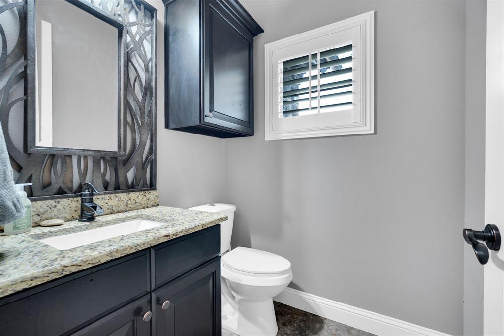 5811 Limestone Lane Midlothian, TX 76065 - Photo 25 of 40 a bathroom with a granite countertop toilet sink and mirror
