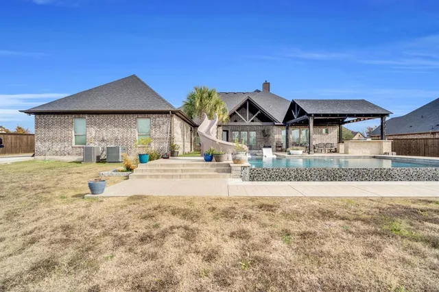 a view of a house with outdoor space and sitting area