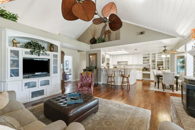 a living room with furniture and a kitchen view