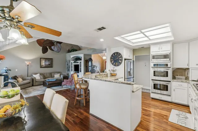 a spacious bedroom with a bed and a chandelier