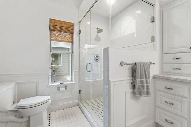 a living room filled with furniture and a large window