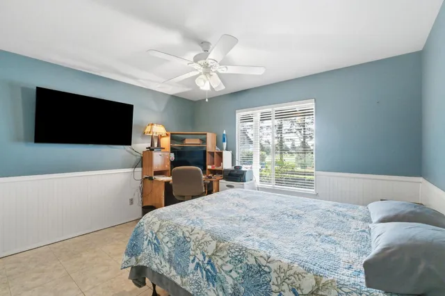 a view of house with space and trees in the background