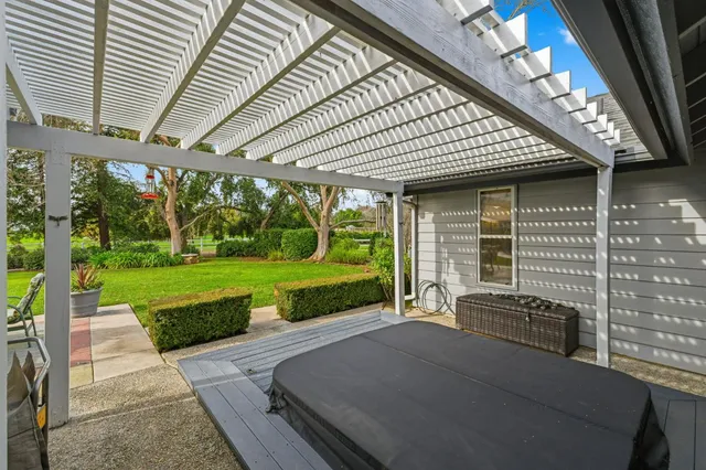 a swimming pool with outdoor seating and yard