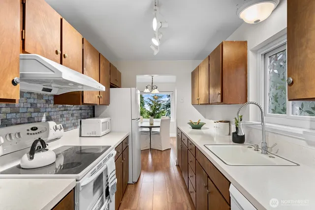 a kitchen with a sink stove and cabinets