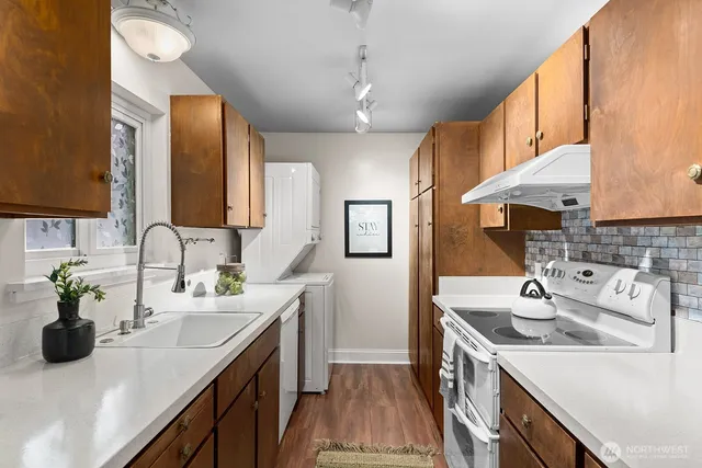 a kitchen with a sink double vanity and a window