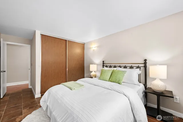 a bedroom with a bed and a lamp