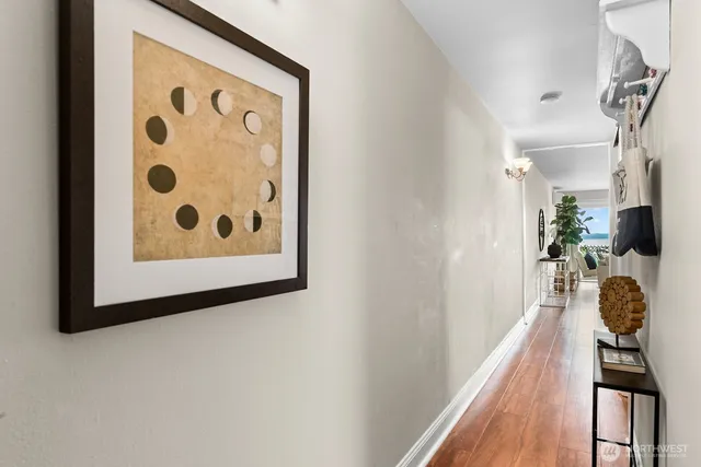 a view of a hallway with wooden floor