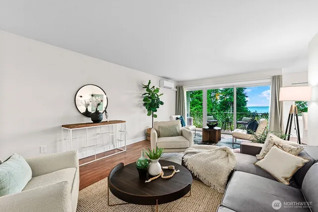 a living room with furniture potted plant and a large window