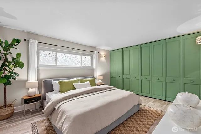 a bedroom with a large bed and a window