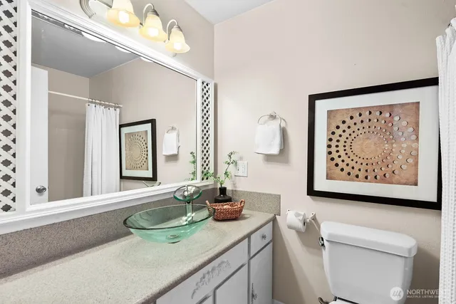 a bathroom with a sink a mirror and a toilet