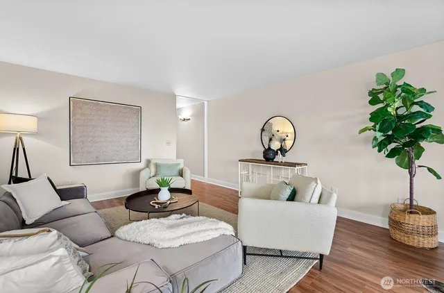 a living room with furniture a potted plant and a lamp