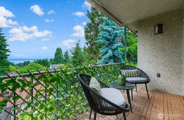 a view of balcony with furniture and a potted plant