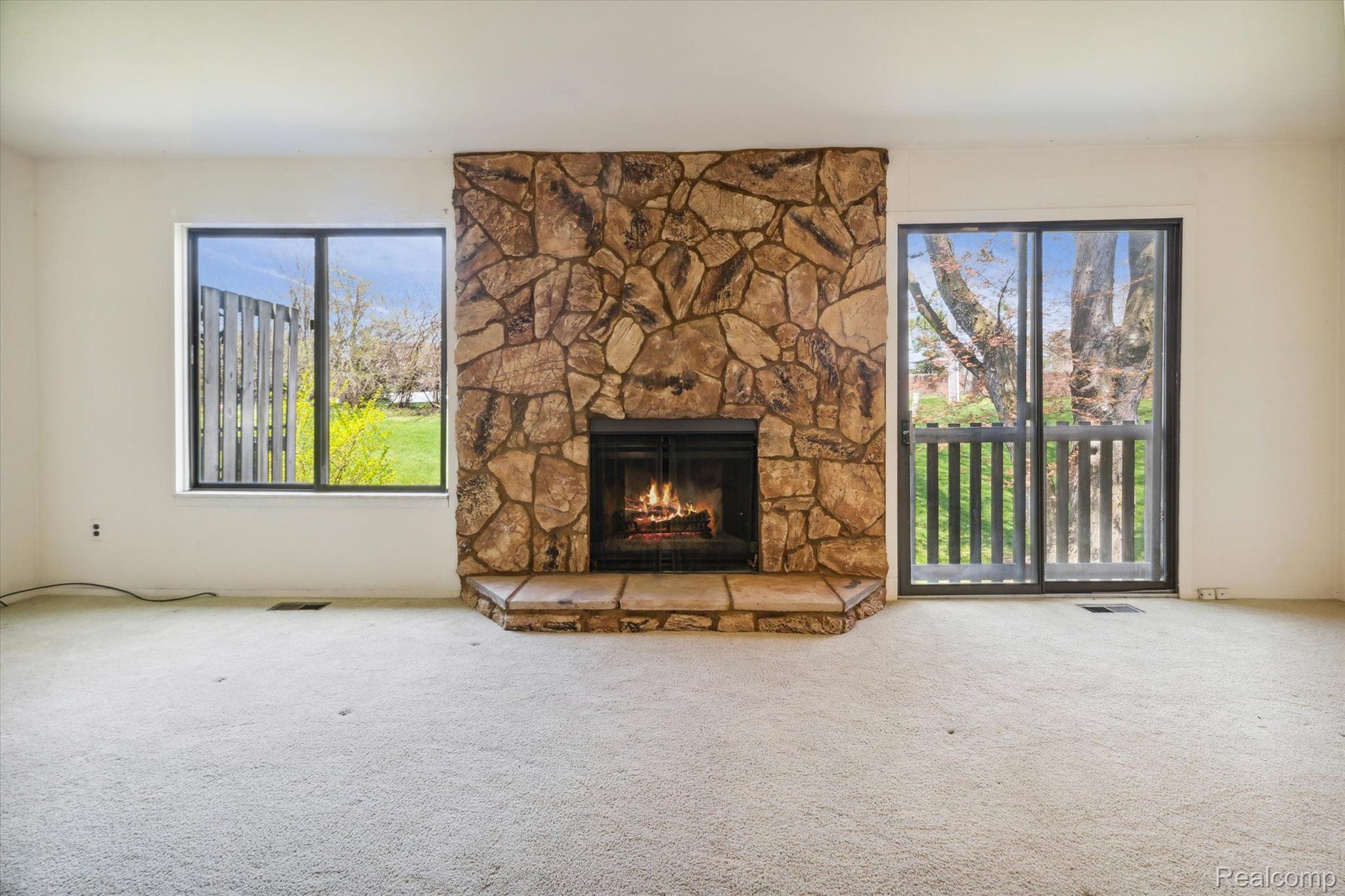 1104 Willow Grove Court Rochester, MI 48307 - Photo 12 of 38 Gas fireplace surrounded by river rock
