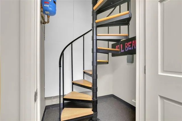 a view of staircase with white walls and a window