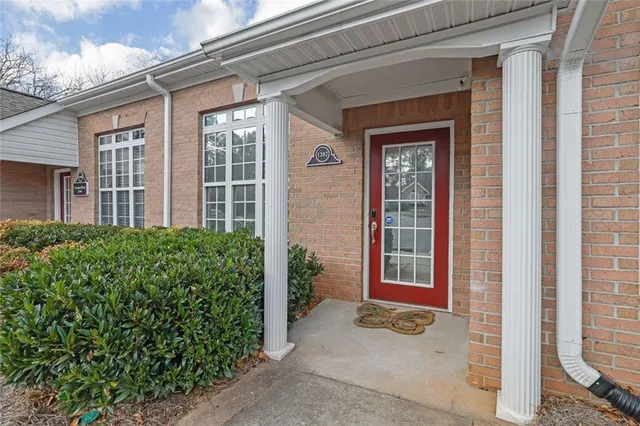 a view of a brick house with potted plants