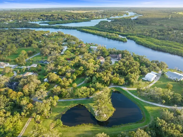 an aerial view of a house with a lake view