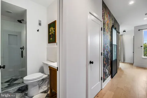 a kitchen with stainless steel appliances granite countertop a table chairs and a refrigerator