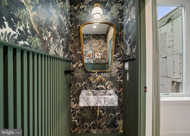 a view of a hallway with paintings on the wall