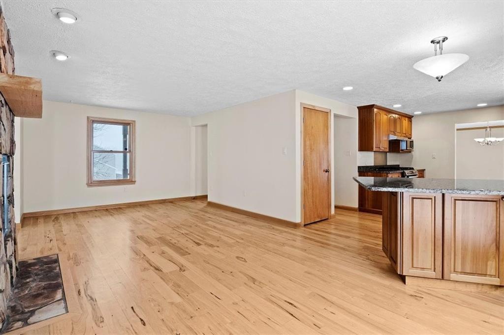 32 Canter Drive Sewickley, PA 15143 - Photo 8 of 25 a view of kitchen and empty room with wooden floor and windows
