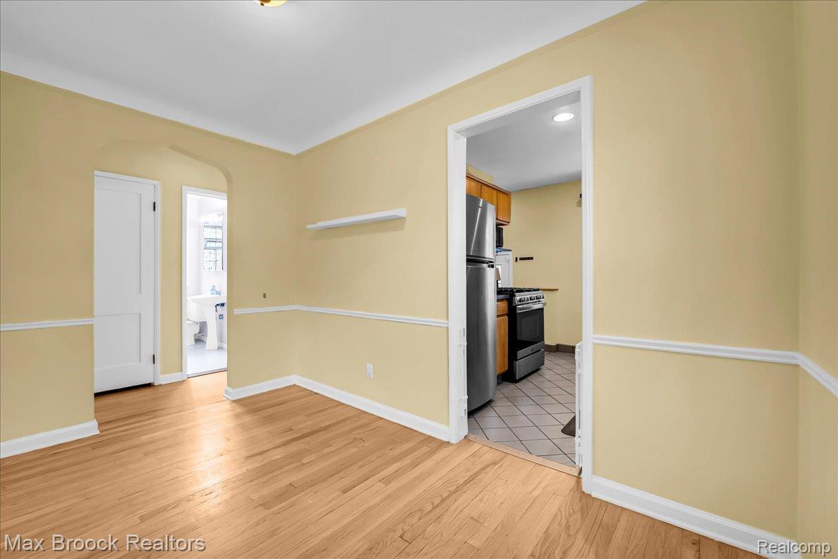 1311 Harvard Road Berkley, MI 48072 - Photo 5 of 29 Spare room with arched walkways and light wood finished floors