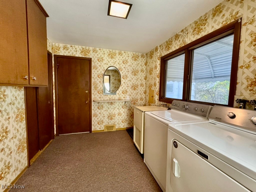 4769 Edenwood Road Cleveland, OH 44121 - Photo 8 of 27 Washroom featuring wallpapered walls, dark colored carpet, washer and dryer, and cabinet space