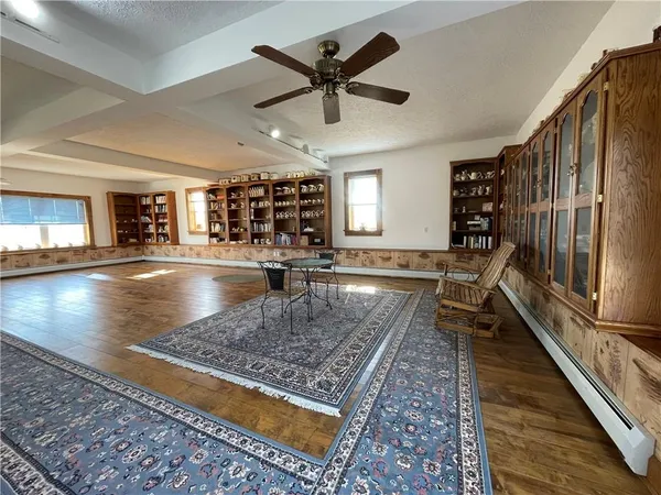 an open space with lots of furniture and wooden floor