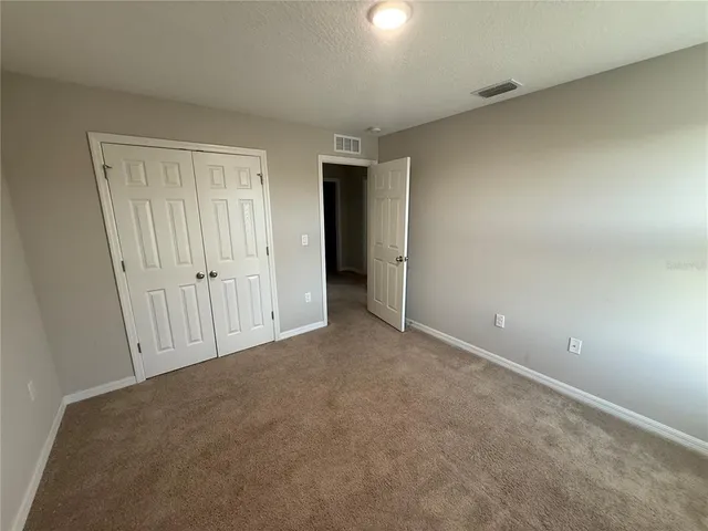 an empty room with closet area