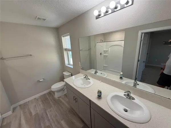 a spacious bathroom with a sink and a mirror