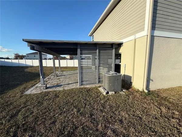 a backyard of a house with table and chairs