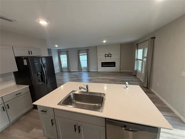 a kitchen with a sink a stove and refrigerator